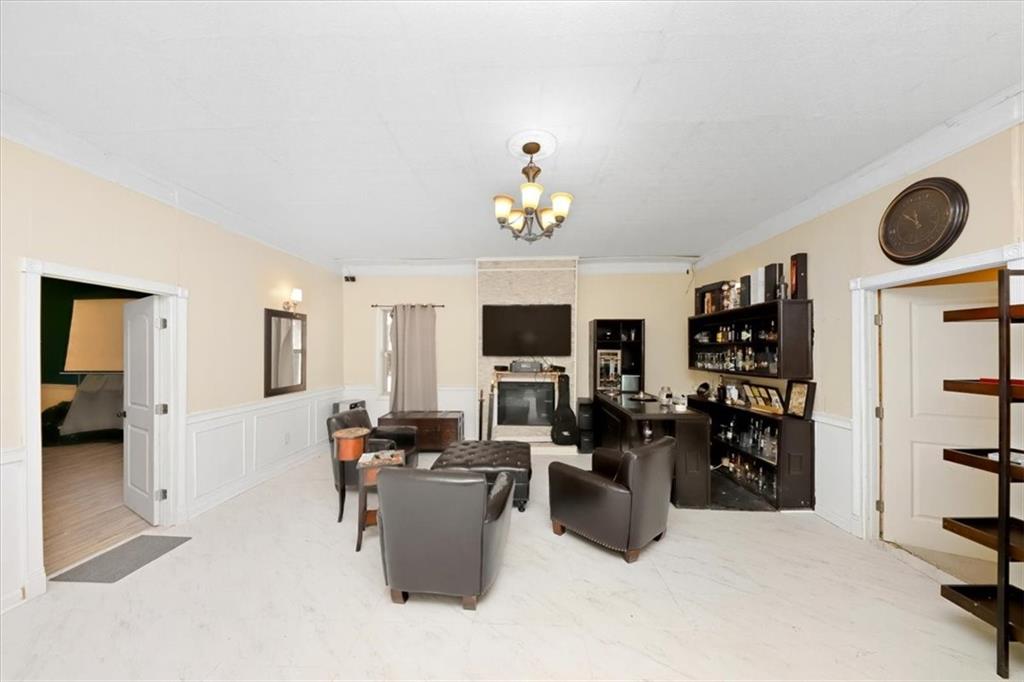 4058 Rosebay Way Southwest Conyers, GA 30094 - Photo 44 of 55 a living room with furniture a flat screen tv and a refrigerator