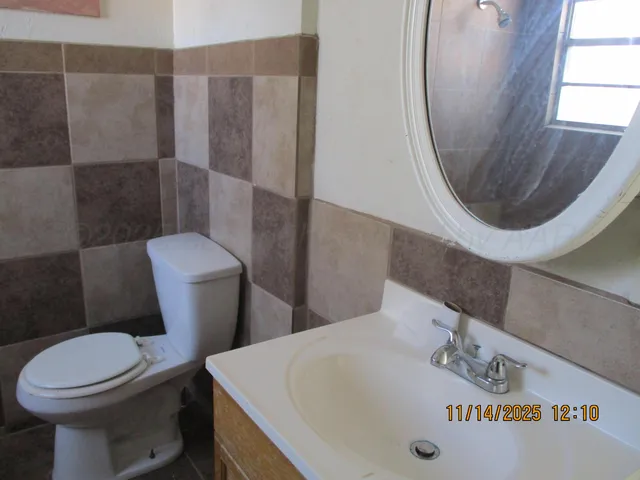 a white toilet sitting next to a bathroom sink