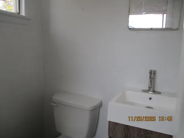 a white toilet sitting next to a bathroom sink