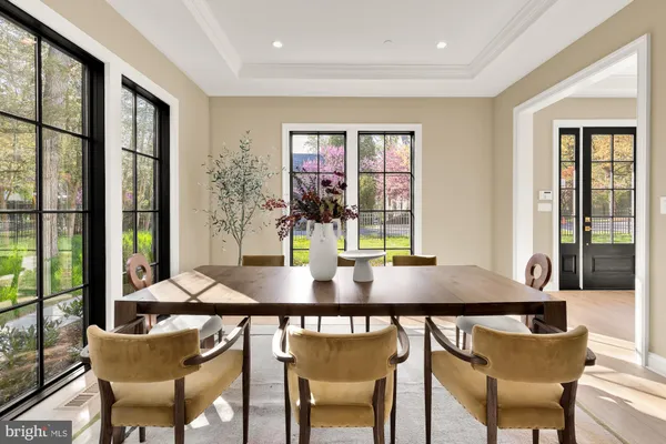 a spacious kitchen with stainless steel appliances granite countertop a sink a stove and a wooden floors