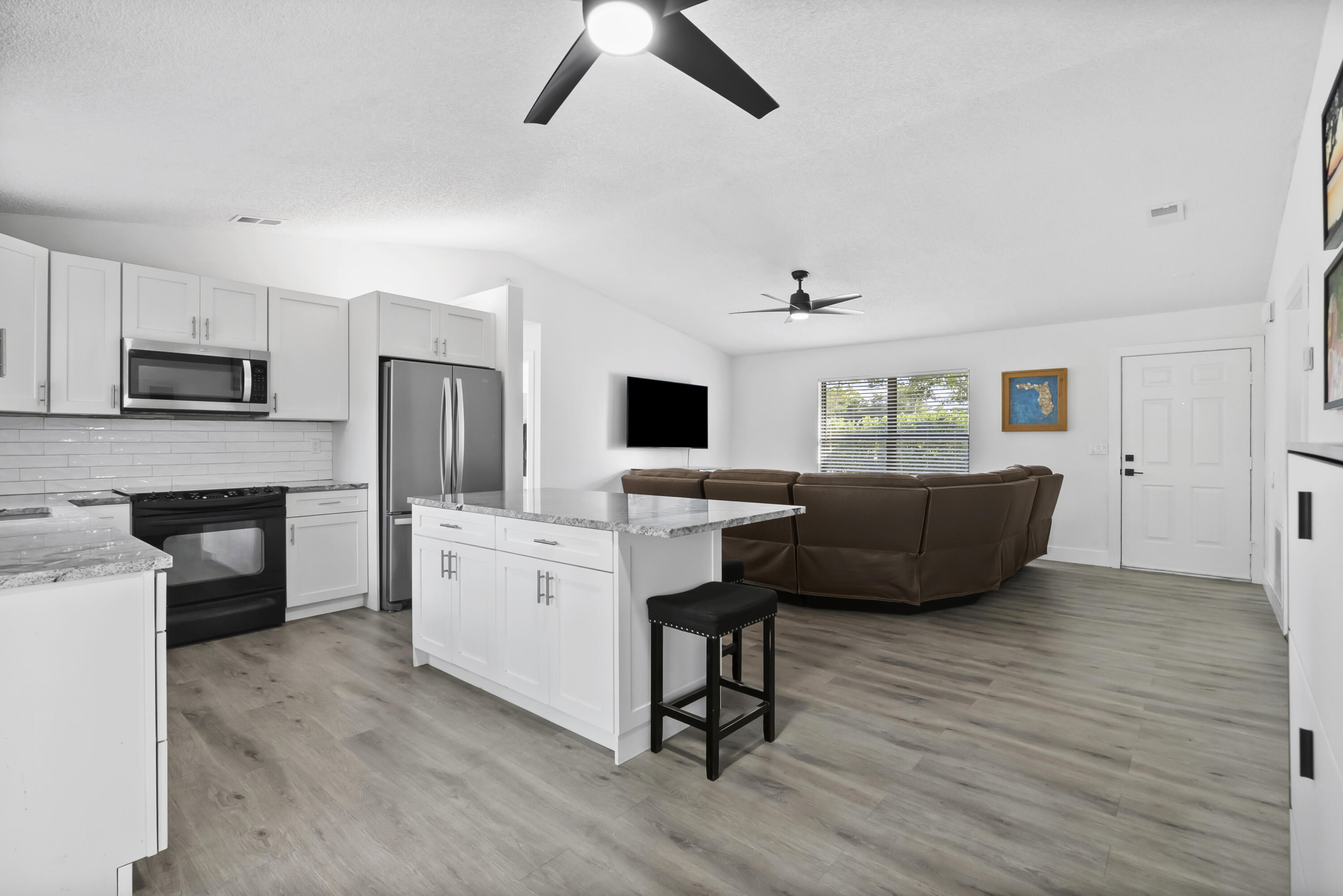 17493 41st Road North The Acreage, FL 33470 - Photo 14 of 45 a living room with furniture a fireplace and a flat screen tv