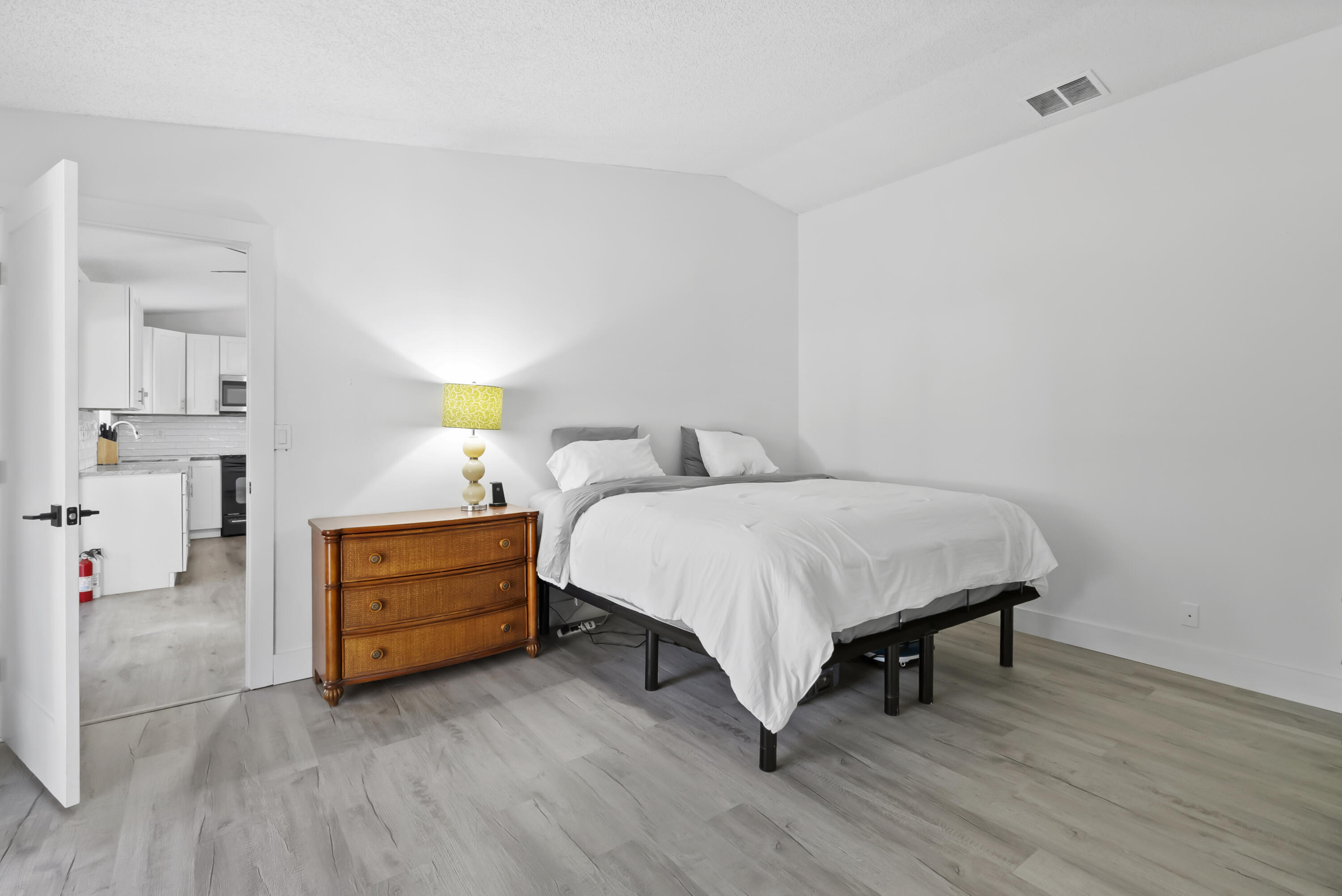 17493 41st Road North The Acreage, FL 33470 - Photo 16 of 45 a bed room with a bed and a lamp