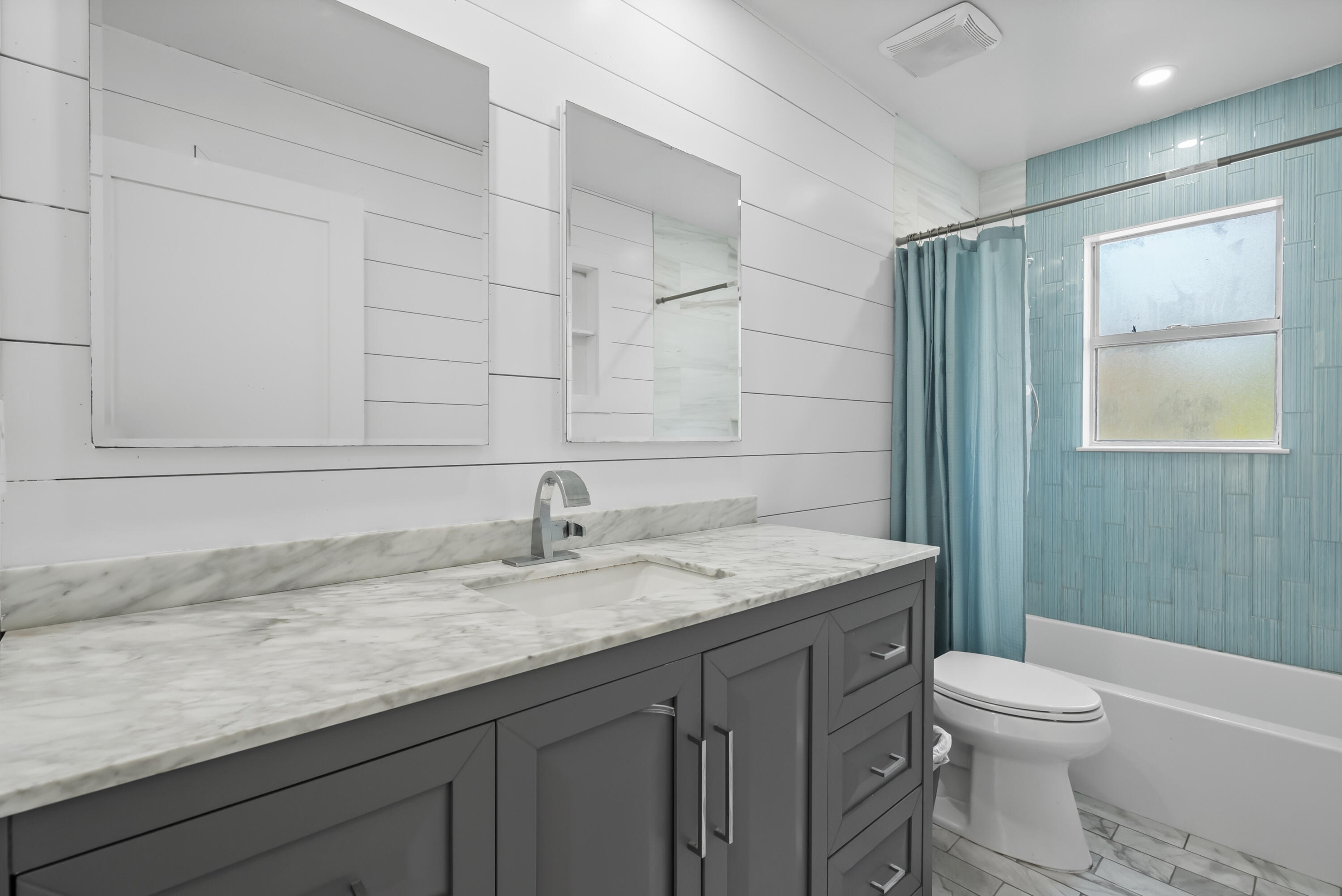 17493 41st Road North The Acreage, FL 33470 - Photo 23 of 45 a bathroom with a granite countertop sink toilet and shower