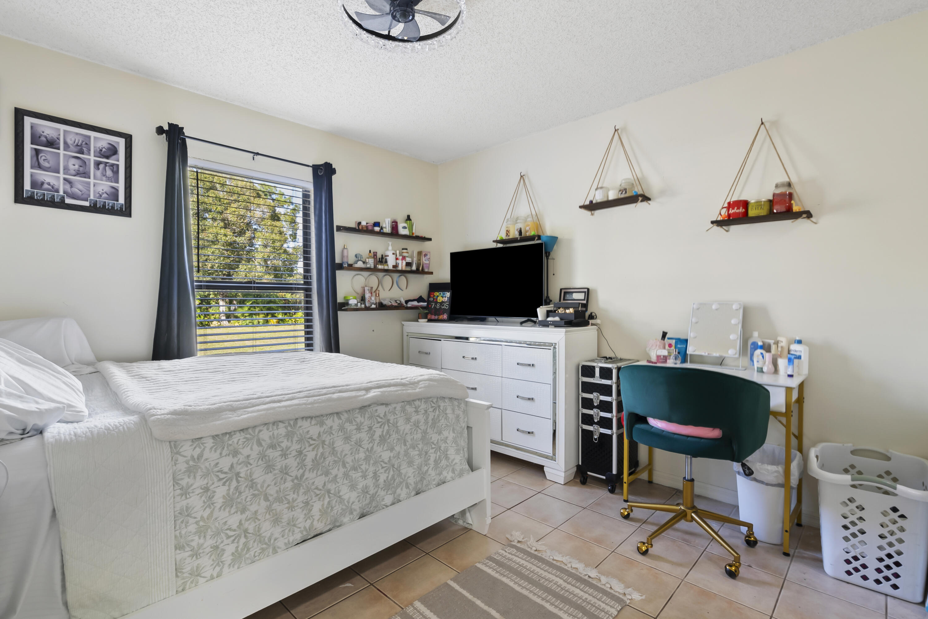 17493 41st Road North The Acreage, FL 33470 - Photo 25 of 45 a bedroom with a bed a flat screen tv and dresser