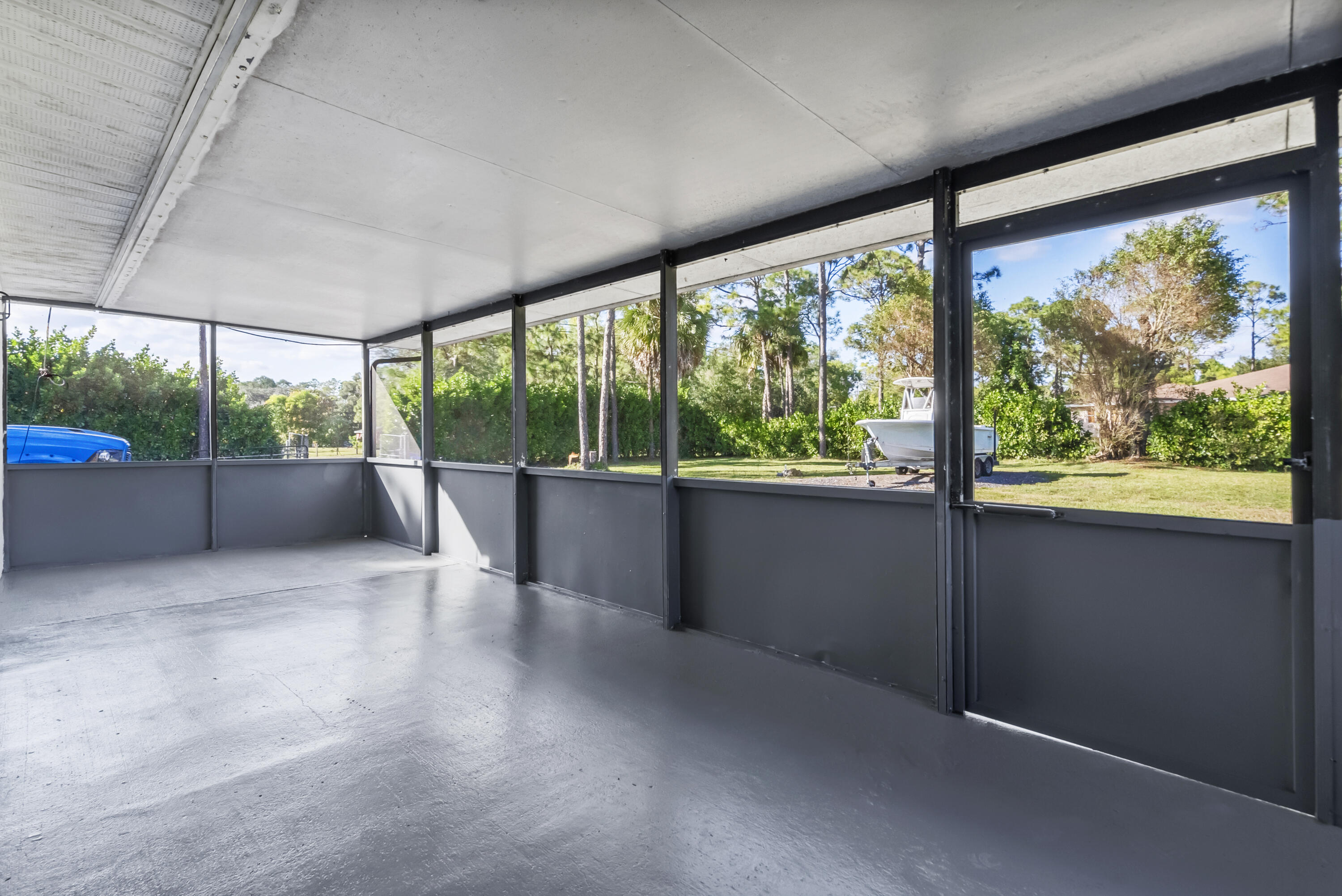 17493 41st Road North The Acreage, FL 33470 - Photo 28 of 45 wooden floor in an empty room with a floor to ceiling window