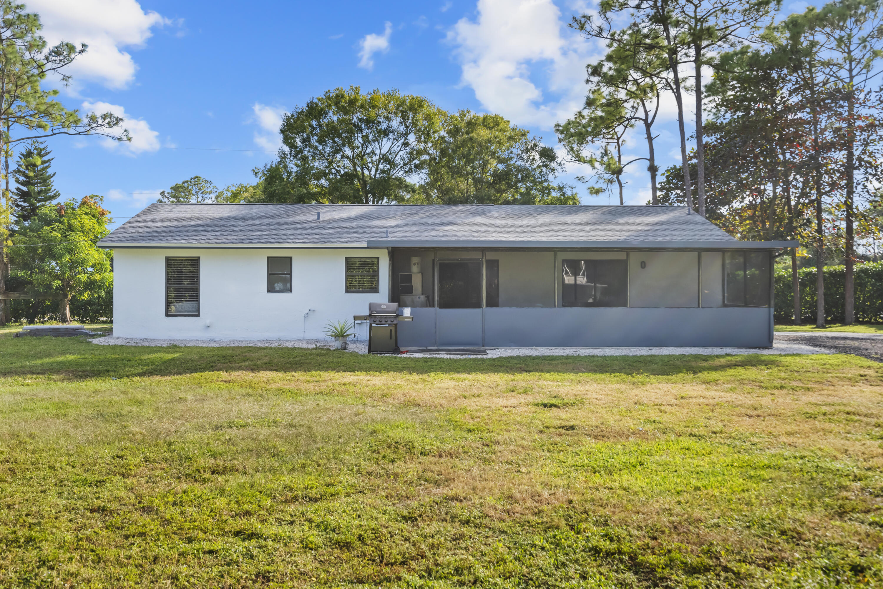 17493 41st Road North The Acreage, FL 33470 - Photo 31 of 45 a front view of a house with a garden