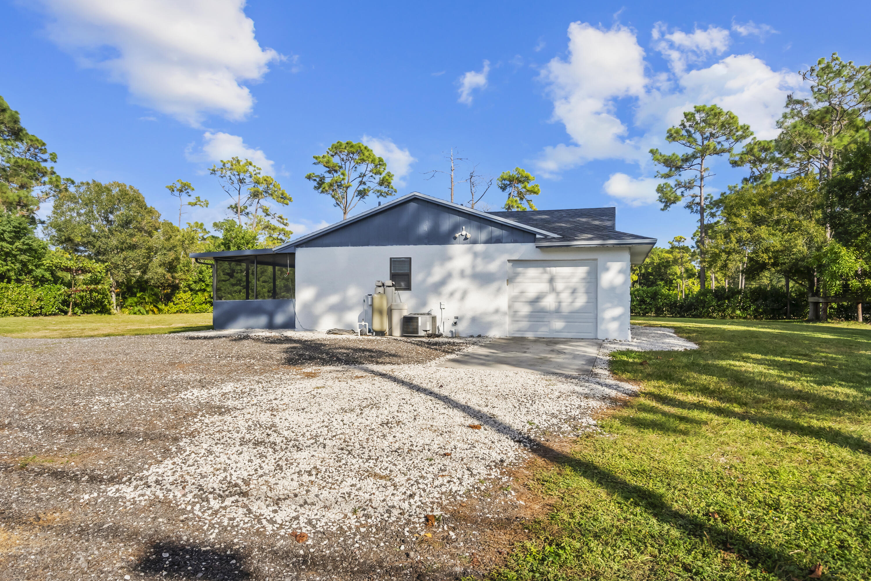 17493 41st Road North The Acreage, FL 33470 - Photo 32 of 45 a view of a house with a yard and a garden