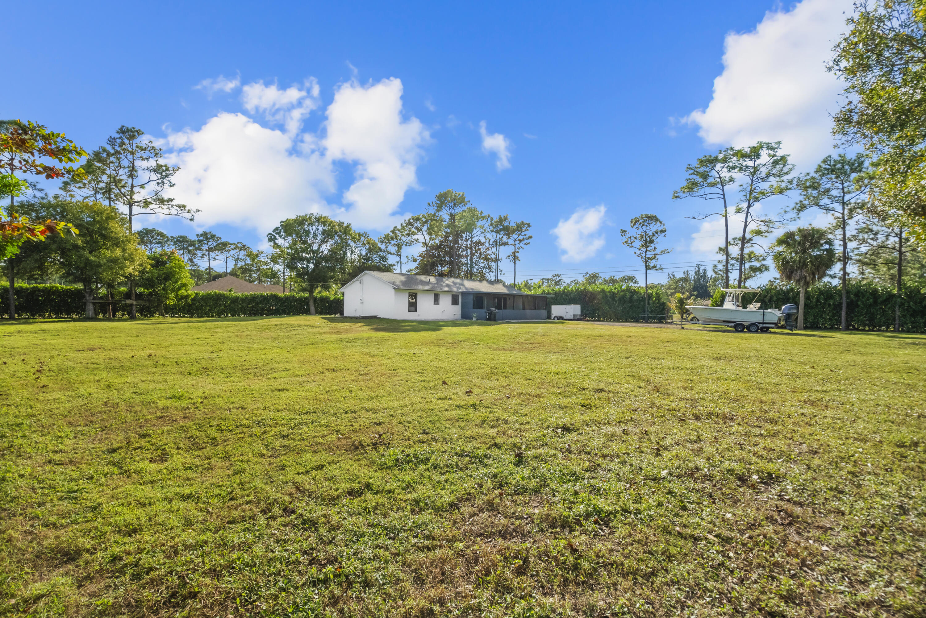 17493 41st Road North The Acreage, FL 33470 - Photo 36 of 45 a view of a swimming pool with an ocean view
