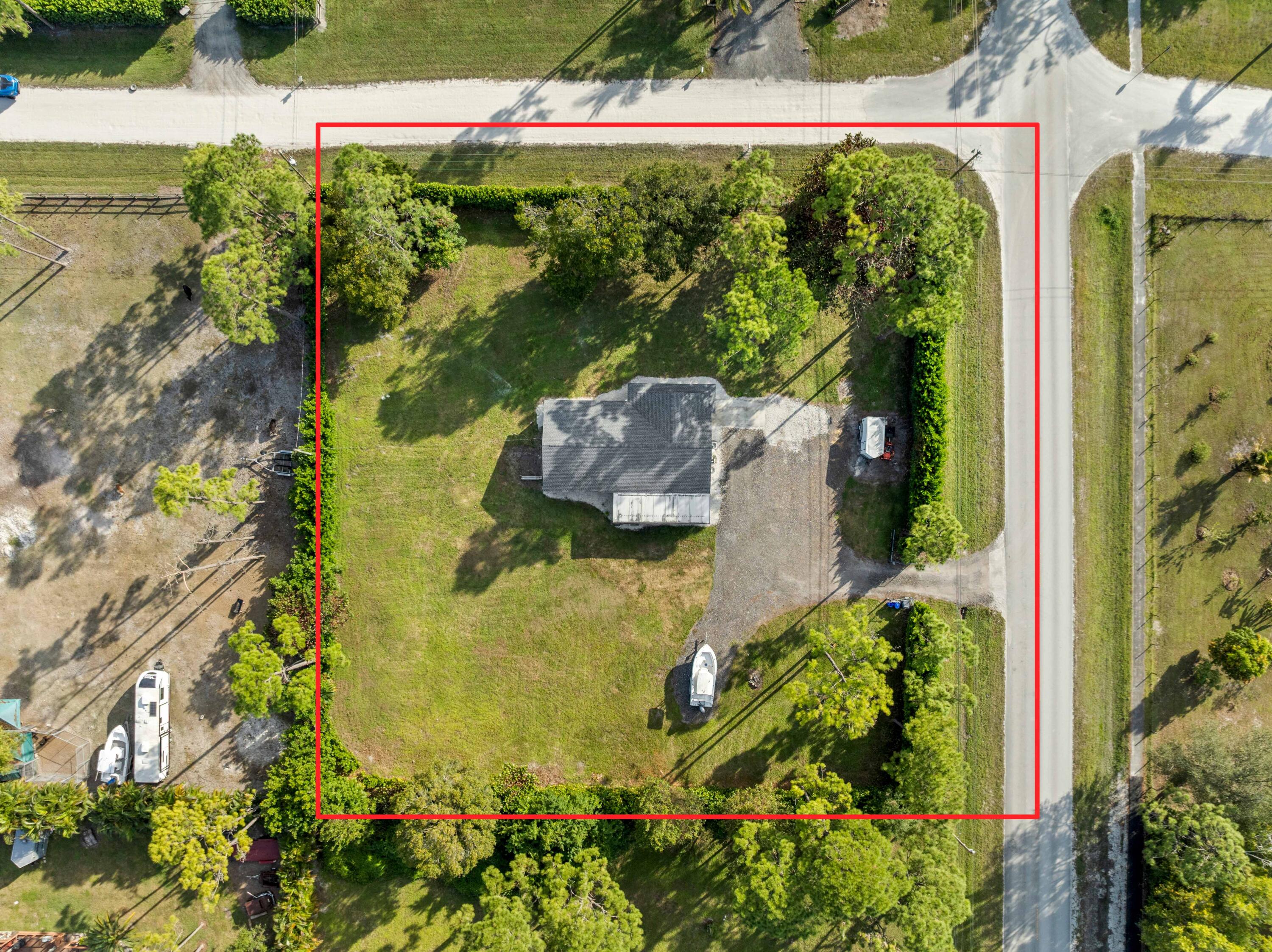 17493 41st Road North The Acreage, FL 33470 - Photo 40 of 45 an aerial view of a house with a garden and lake view