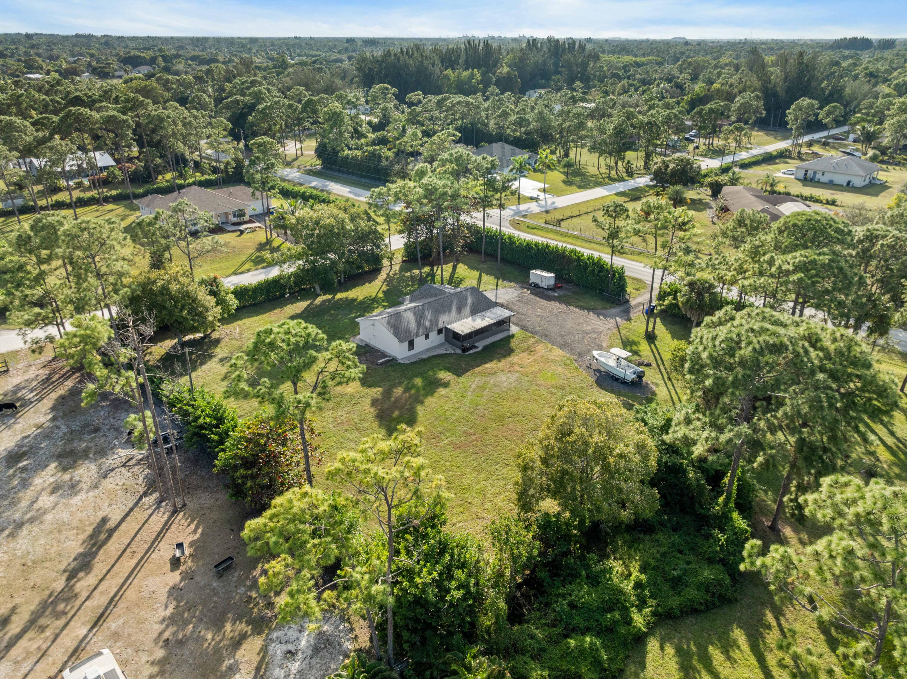 17493 41st Road North The Acreage, FL 33470 - Photo 42 of 45 an aerial view of residential houses with outdoor space and trees