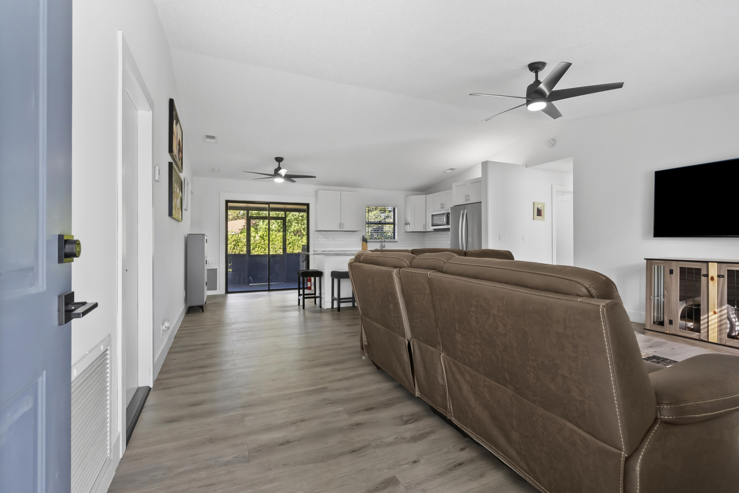 17493 41st Road North The Acreage, FL 33470 - Photo 5 of 45 a living room with a bed furniture and a flat screen tv