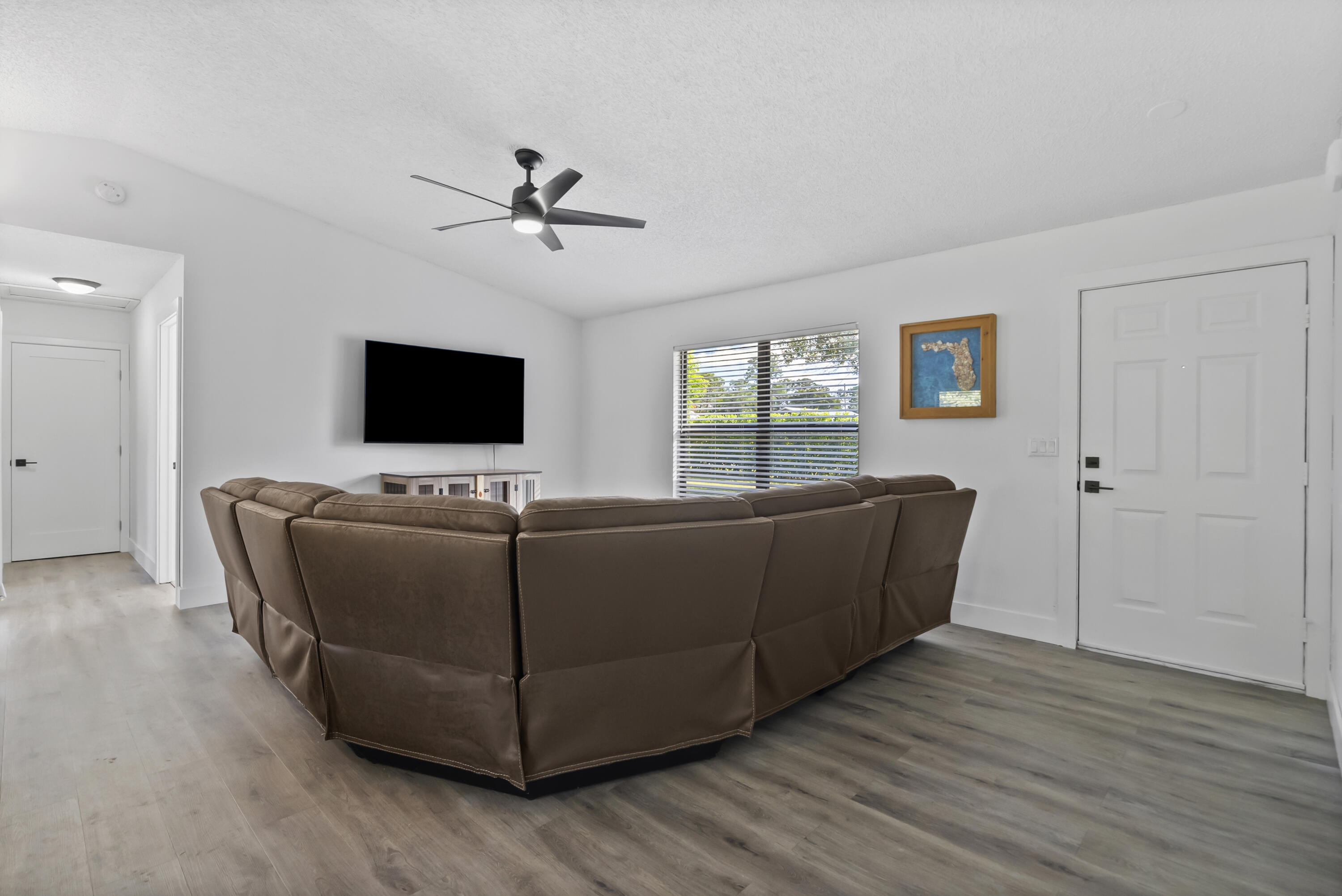 17493 41st Road North The Acreage, FL 33470 - Photo 6 of 45 a living room with furniture and a flat screen tv