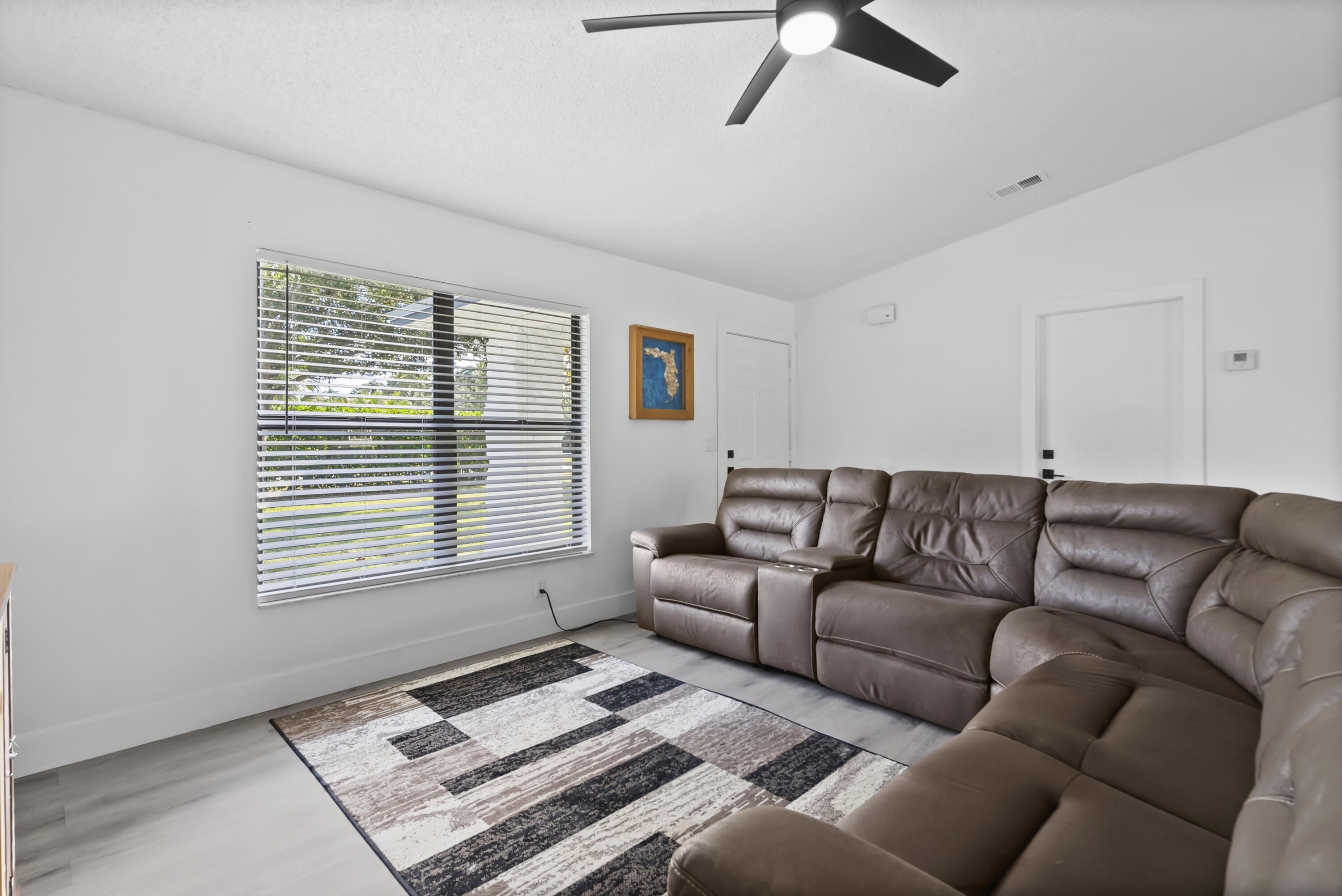 17493 41st Road North The Acreage, FL 33470 - Photo 7 of 45 a living room with furniture and a window