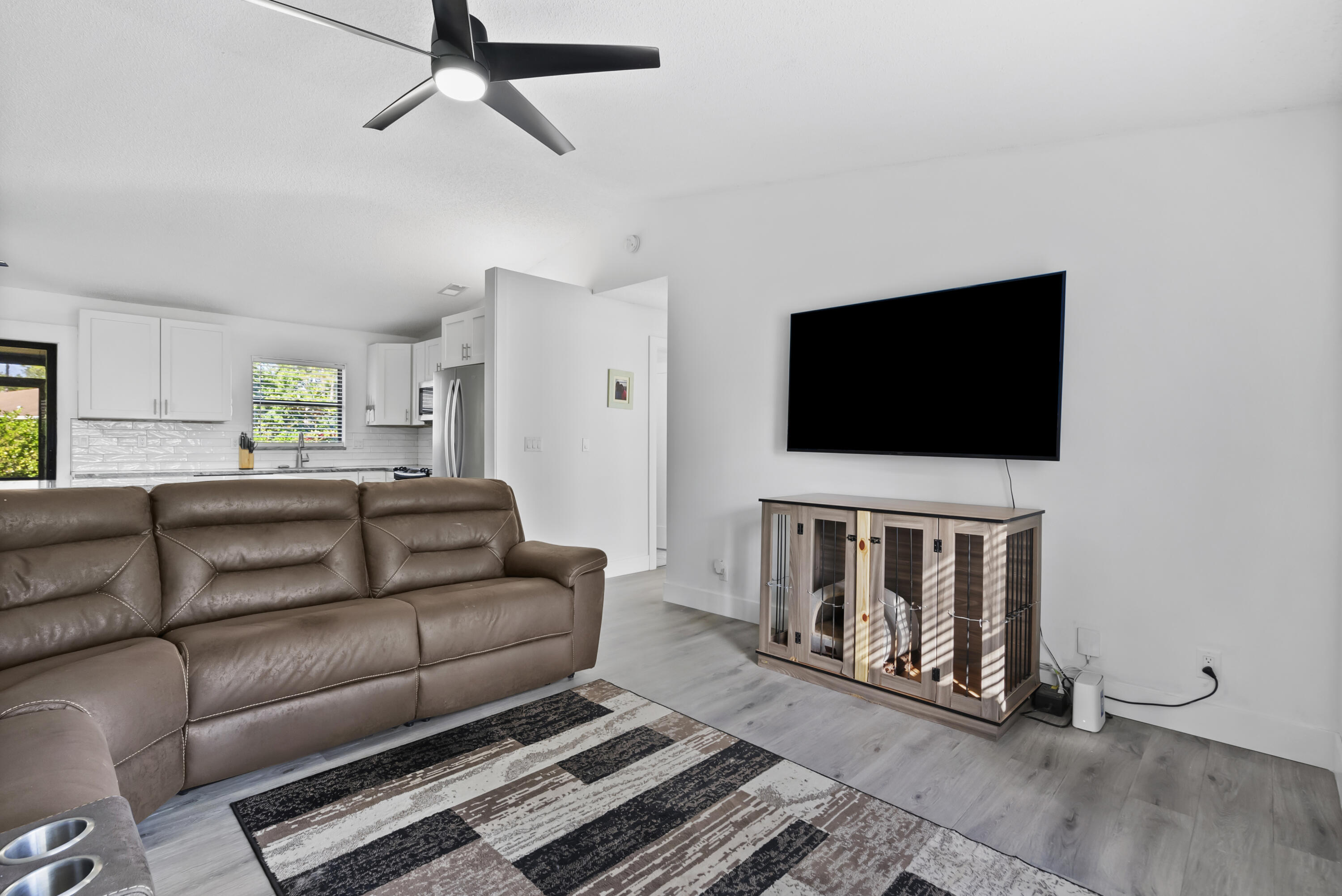17493 41st Road North The Acreage, FL 33470 - Photo 9 of 45 a living room with furniture and a flat screen tv