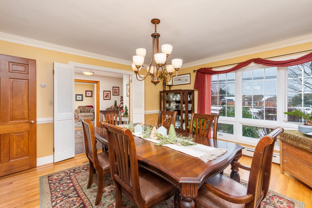 205 Cattle Scales Road Waynesboro, VA 22980 - Photo 26 of 75 a dining room with wooden floor a chandelier a wooden table and chairs