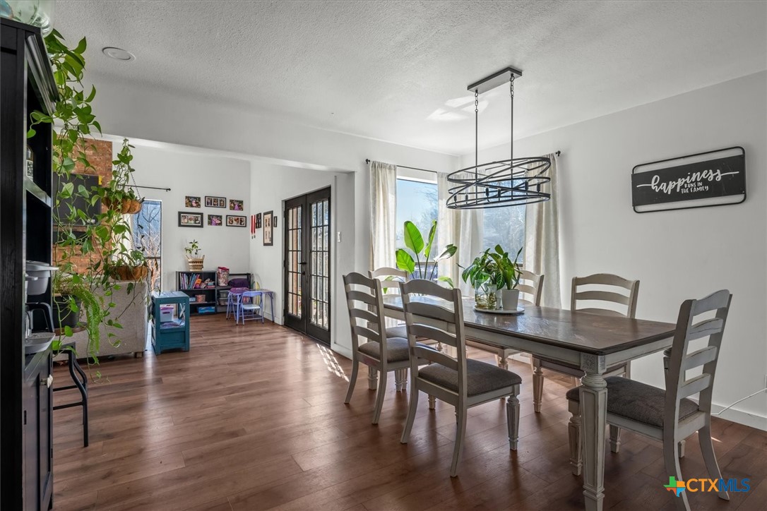 422 Connolly Circle Lockhart, TX 78644 - Photo 11 of 35 a dining room with furniture potted plants and wooden floor