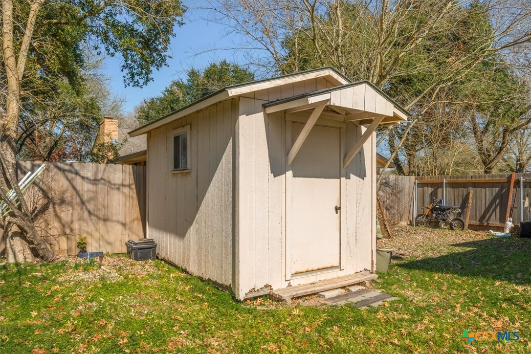 422 Connolly Circle Lockhart, TX 78644 - Photo 33 of 35 a view of a tiny house with a small yard and large tree