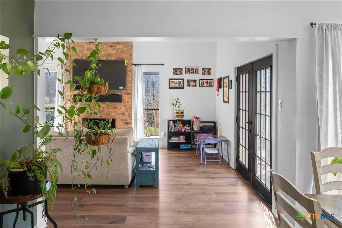 422 Connolly Circle Lockhart, TX 78644 - Photo 7 of 35 a view of a hallway with wooden floor and a potted plant