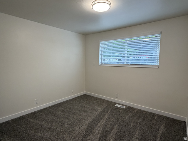 895 East Arrowhead Lane Murray, UT 84107 - Photo 7 of 12 Neutral wall finishes, textured carpet flooring, and white baseboards