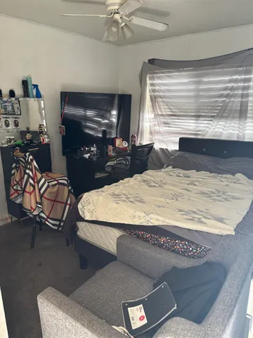 a bed sitting in a room next to a window