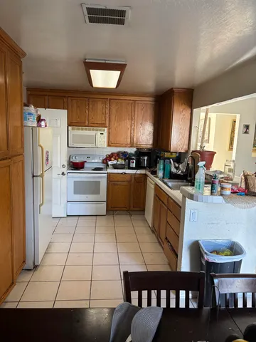 a kitchen with a stove a refrigerator and a dining table