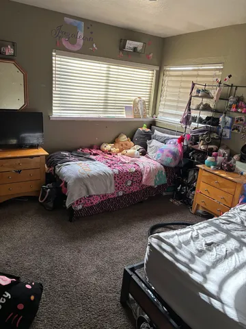 a bedroom with bed and window