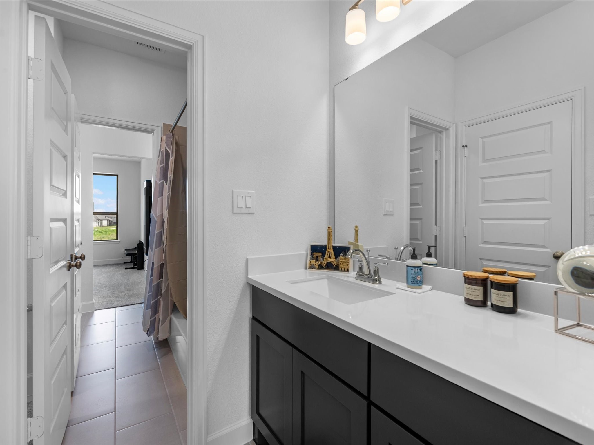 18714 Pistachio Way Manvel, TX 77578 - Photo 31 of 48 The Jack-and-Jill bath offers exceptional functionality with separate vanity areas and a private tub and shower, making busy mornings easier for everyone.