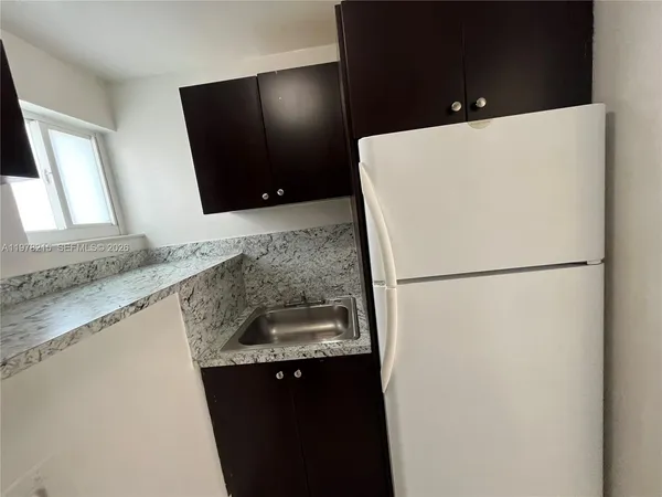 a white refrigerator freezer sitting in a kitchen