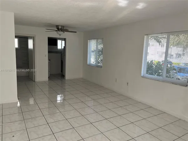 an empty room with windows and closet