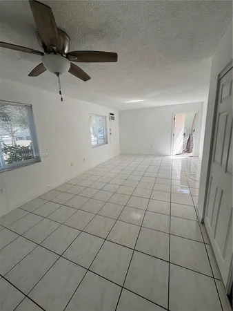 a view of an empty room and a window