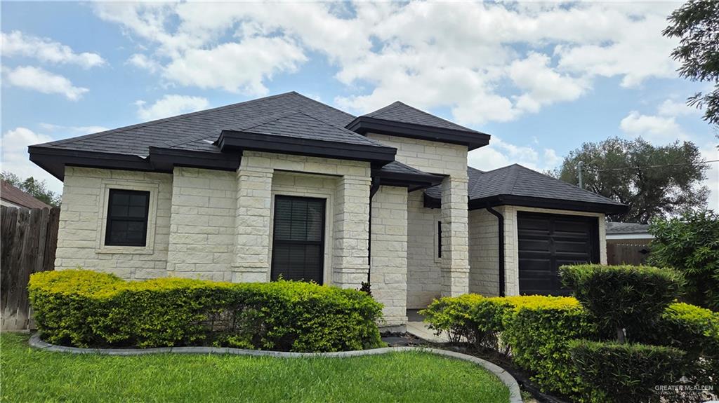a front view of a house with garden
