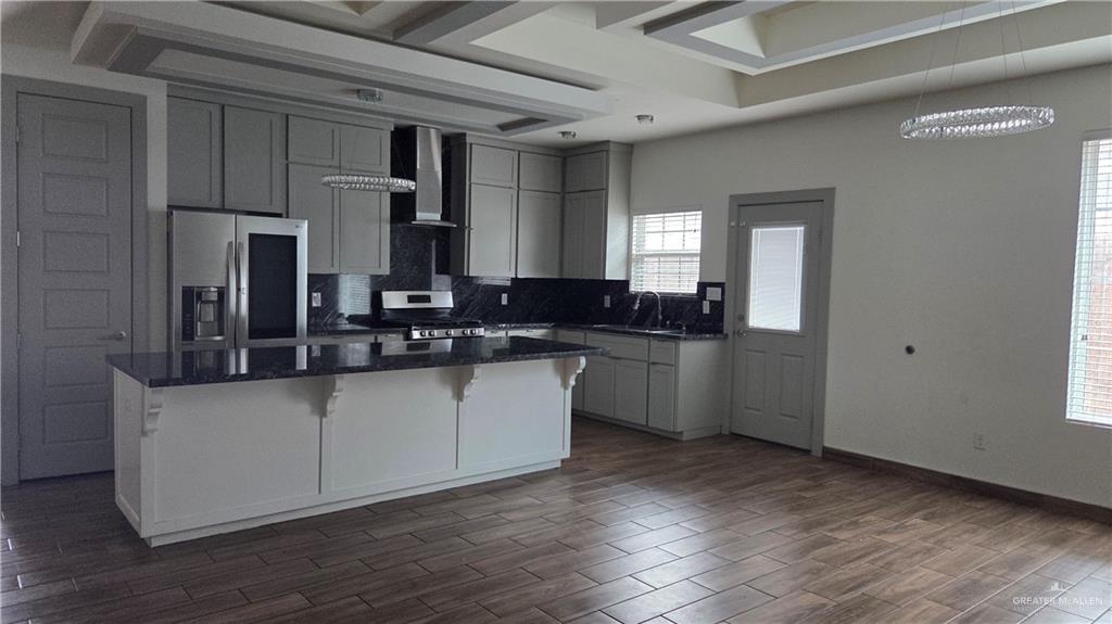 419 North 17th Street, Unit 2 McAllen, TX 78501 - Photo 2 of 10 a kitchen with granite countertop a sink cabinets and wooden floor