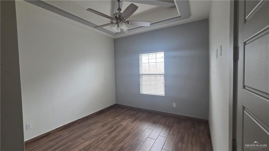 419 North 17th Street, Unit 2 McAllen, TX 78501 - Photo 5 of 10 a view of an empty room with wooden floor and a window
