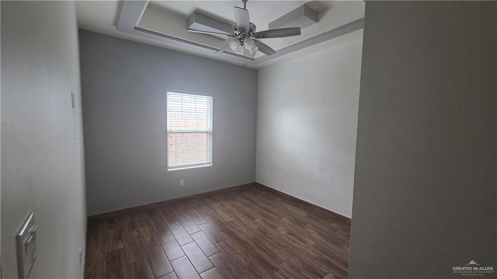 419 North 17th Street, Unit 2 McAllen, TX 78501 - Photo 6 of 10 an empty room with a window and a fan