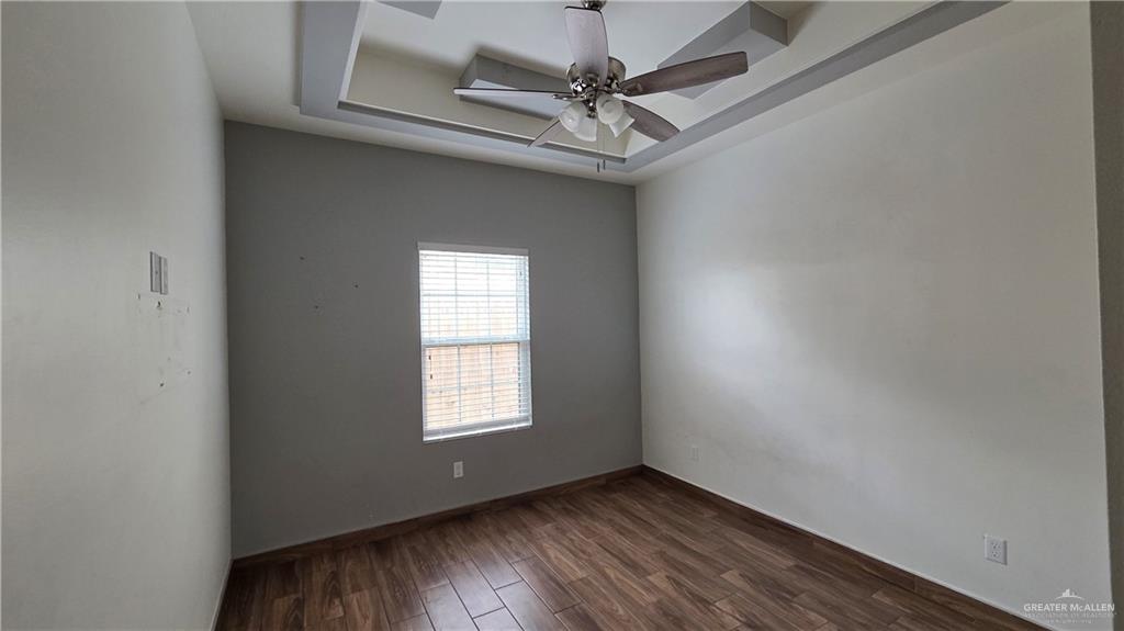 419 North 17th Street, Unit 2 McAllen, TX 78501 - Photo 8 of 10 an empty room with a window and a fan
