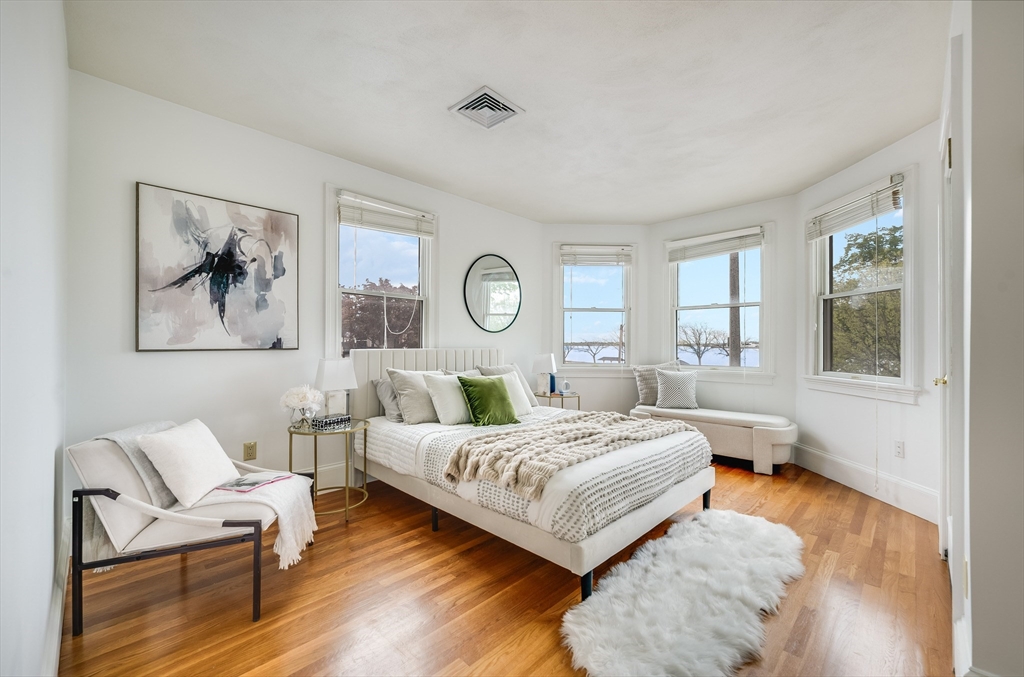 1520 Columbia Road, Unit 2 Boston, MA 02127 - Photo 12 of 16 a bedroom with a bed and wooden floor