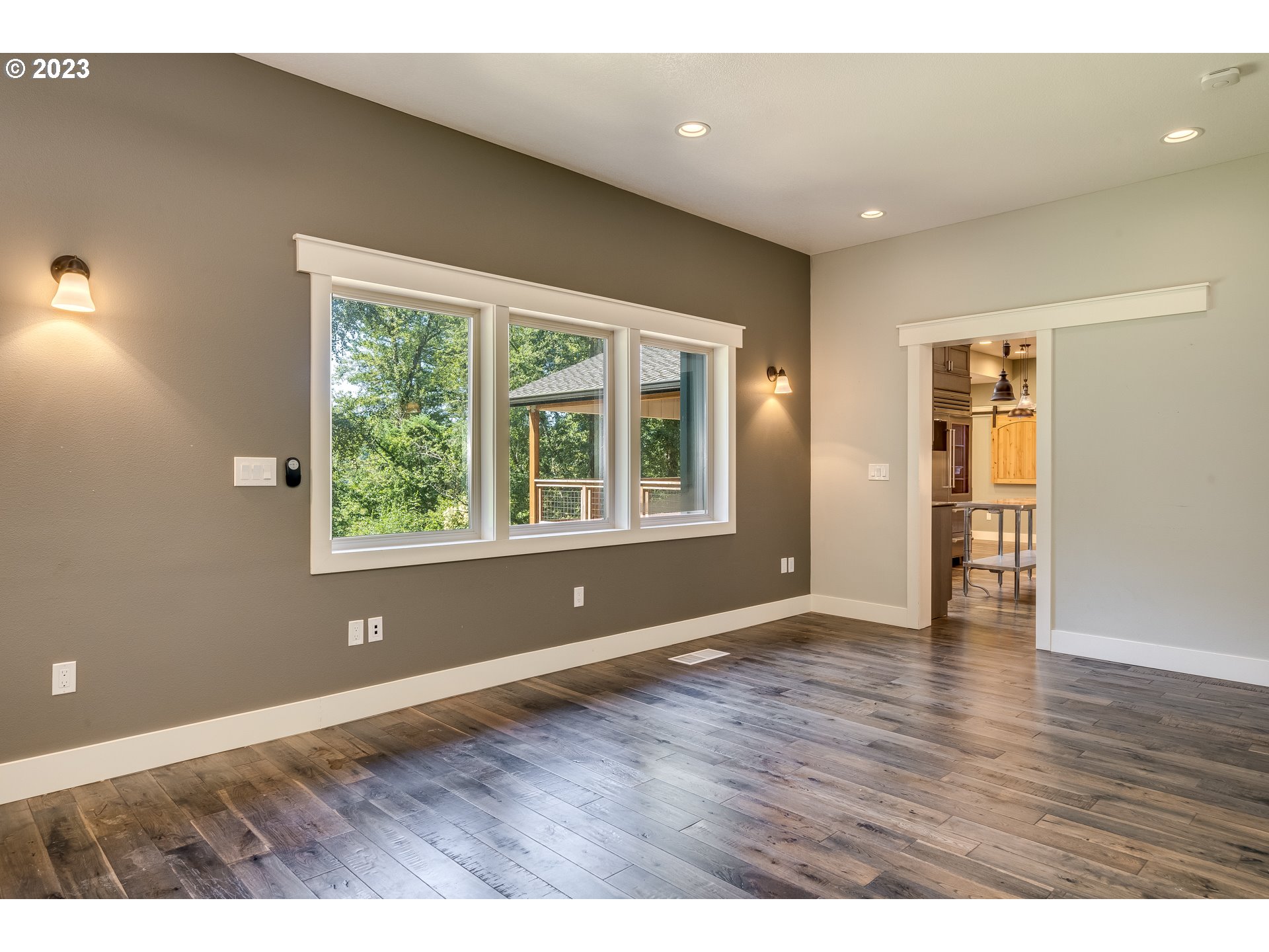 12840 South Carus Road Oregon City, OR 97045 - Photo 17 of 35 an empty room with wooden floor and windows