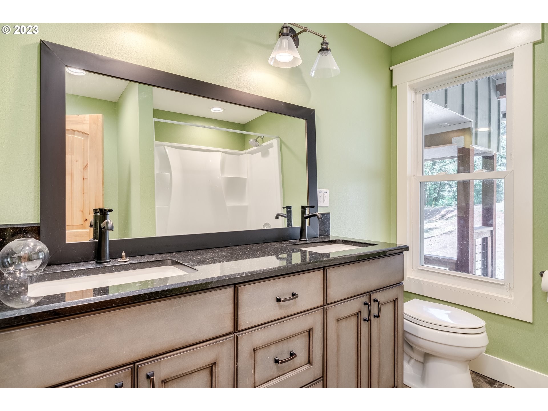 12840 South Carus Road Oregon City, OR 97045 - Photo 19 of 35 a bathroom with a granite countertop sink and a mirror