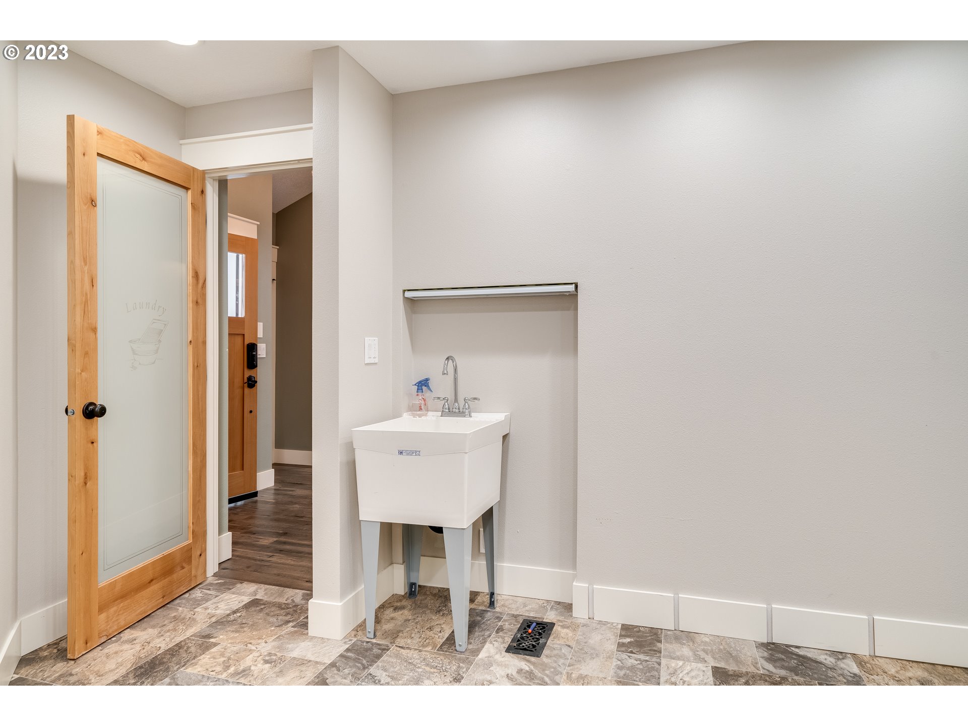 12840 South Carus Road Oregon City, OR 97045 - Photo 20 of 35 a view of a hallway with wooden floor and dining room