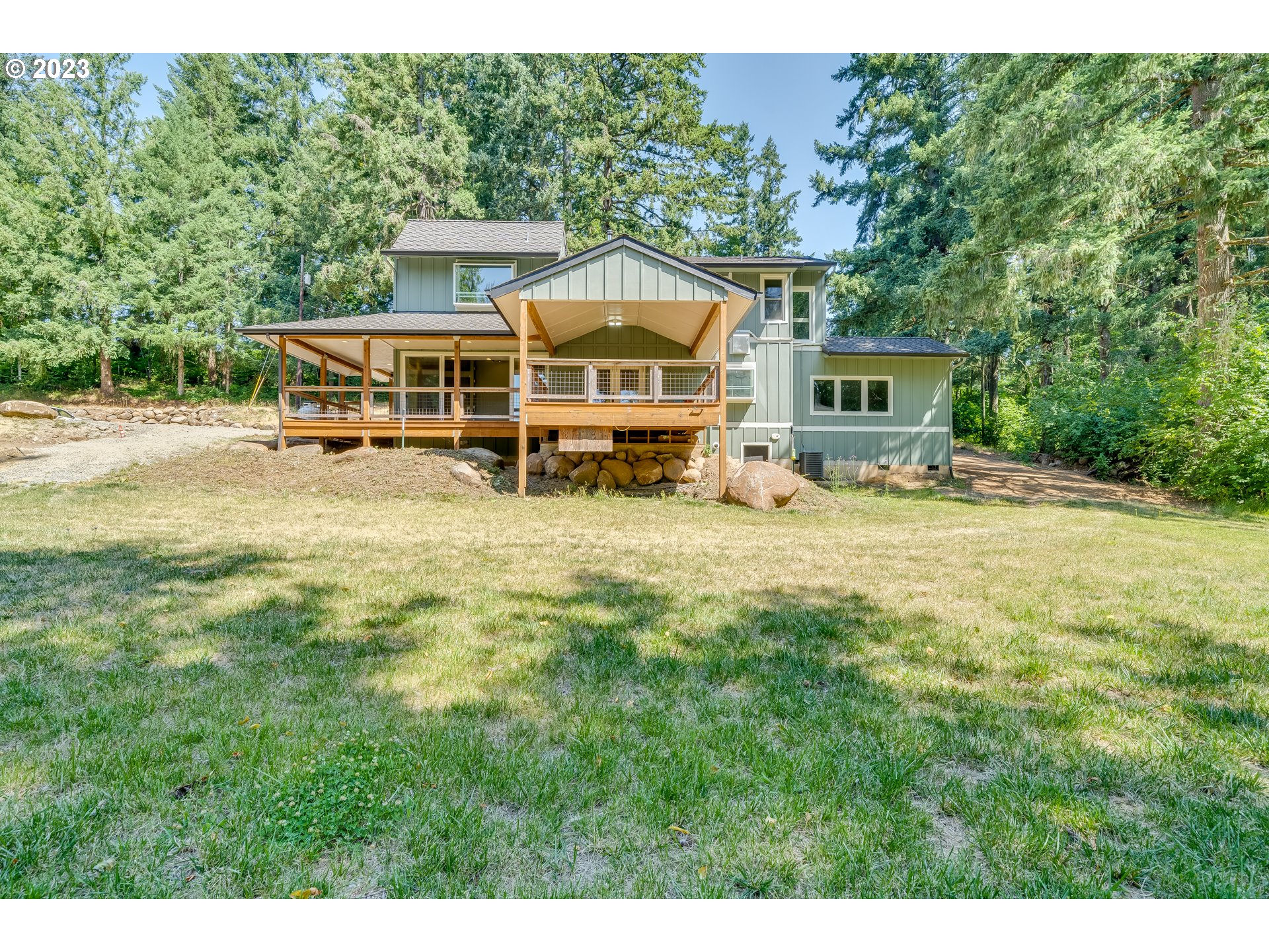 12840 South Carus Road Oregon City, OR 97045 - Photo 4 of 35 a view of a house with yard and sitting area