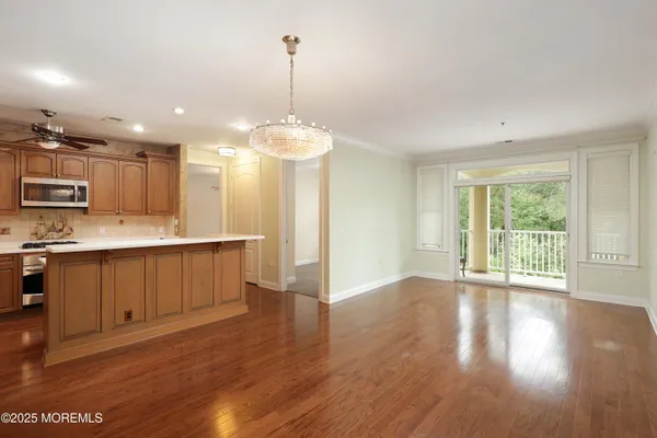 a view of kitchen and kitchen with granite countertop stainless steel appliances