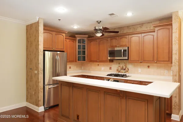 a view of a room with a ceiling fan and a window
