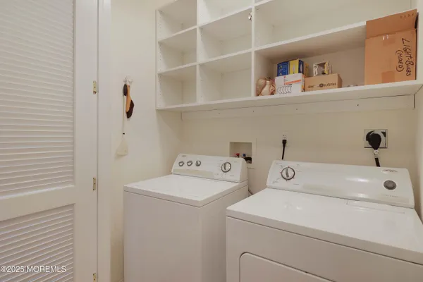 a view of a hallway with wooden floor and door