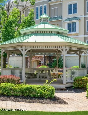 a view of a lake with a building and a table and chairs