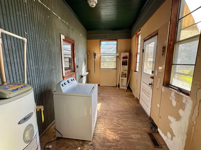 a view of a storage & utility room with a window
