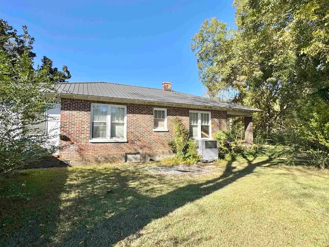 a front view of a house with swimming pool and porch