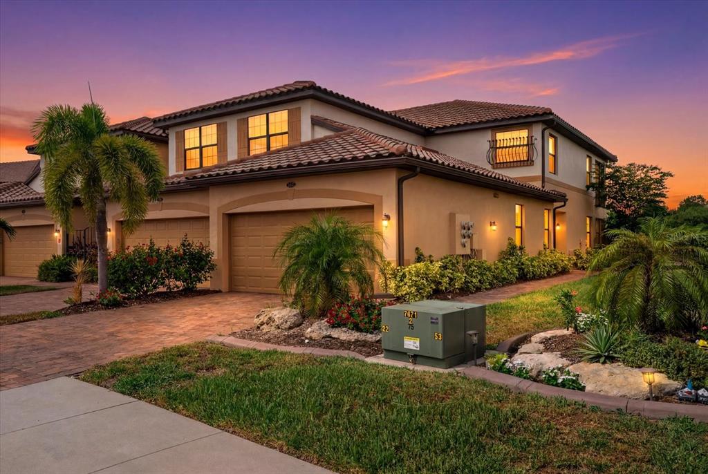 20080 Ragazza Circle, Unit 102 Venice, FL 34293 - Photo 37 of 49 a front view of a house with a yard