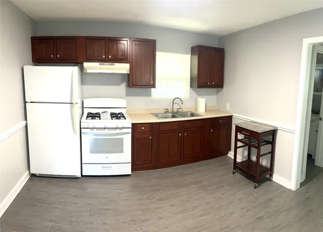 a utility room with sink dryer and washer