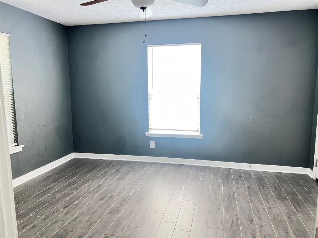 1114 Tillery Street, Unit A Austin, TX 78702 - Photo 8 of 8 an empty room with wooden floor and windows