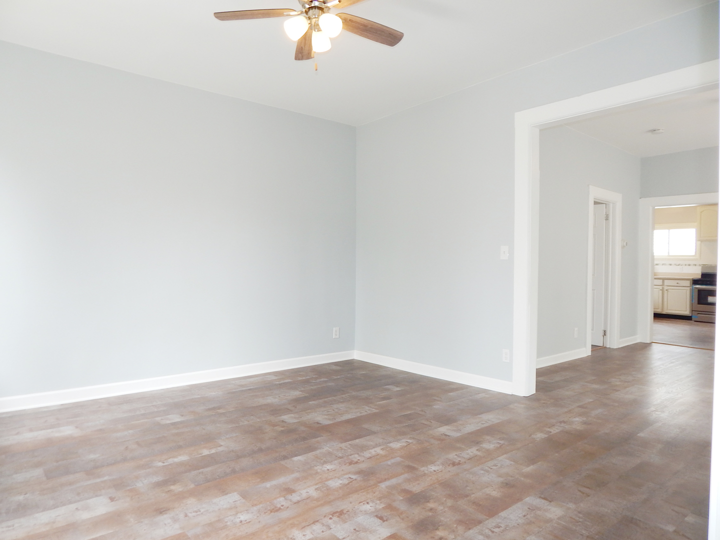 415 North Spring Street Elgin, IL 60120 - Photo 4 of 22 an empty room with a chandelier fan